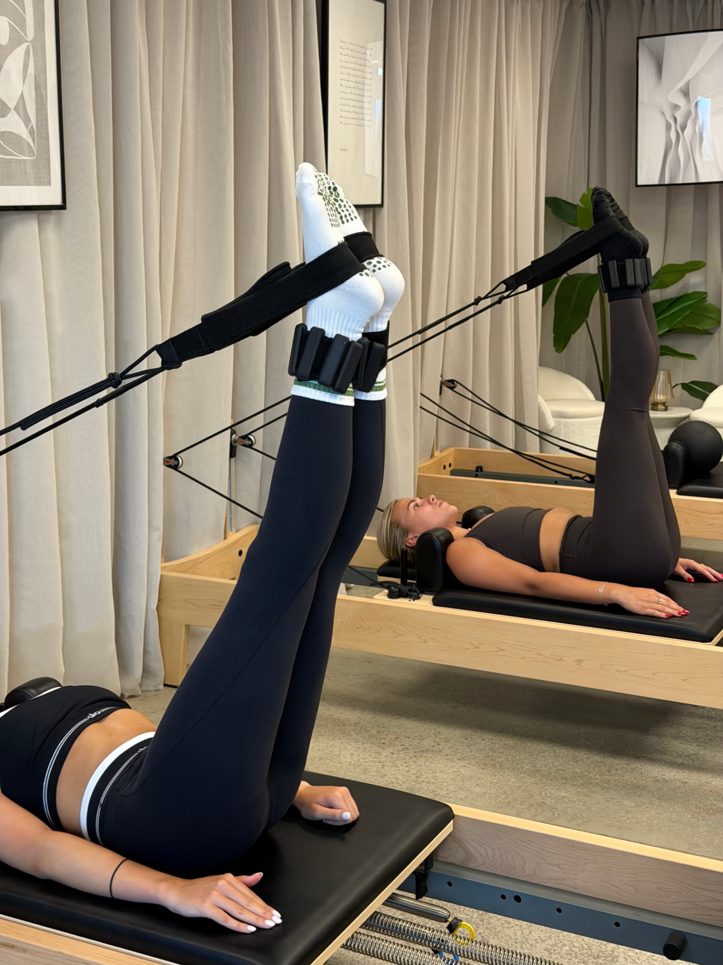 Attendees working through leg work in the Reformer straps at BED Debden